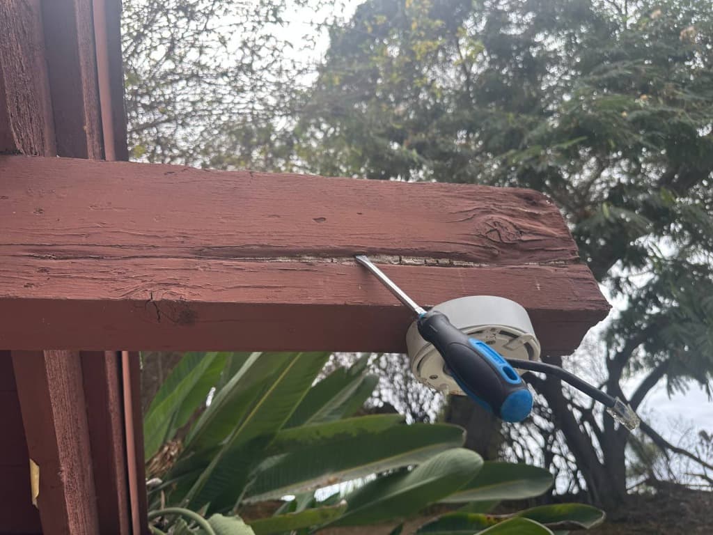 Screwdriver penetrating deeply into rotted structural console beam