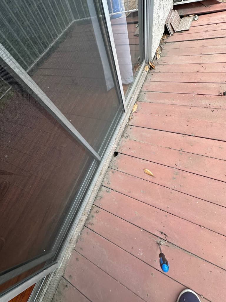 Rotted deck boards near the sliding glass door