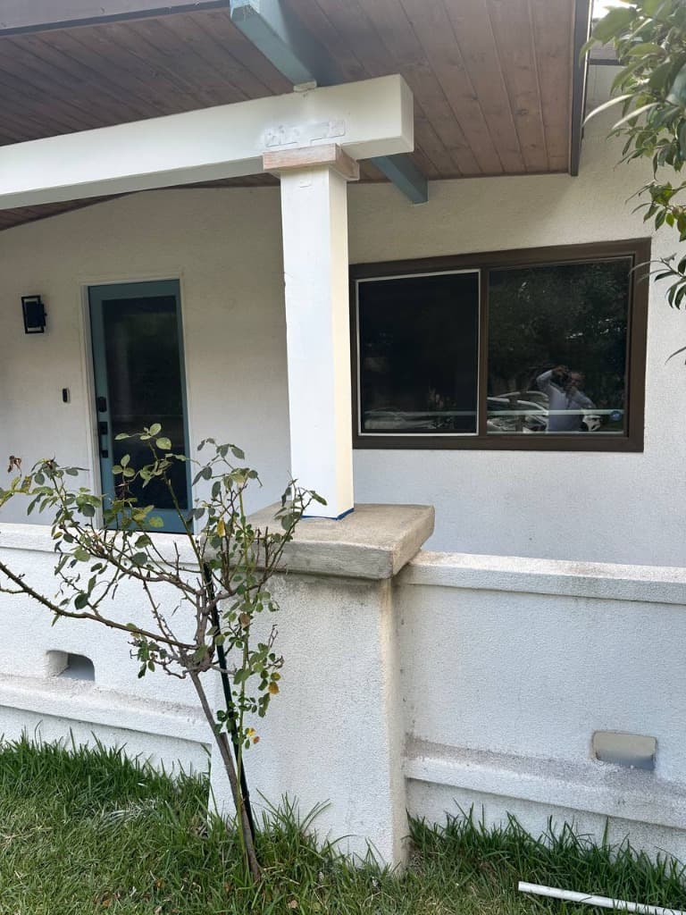 New structural post installed with metal T-strap connector and reconstructed concrete pedestal cap