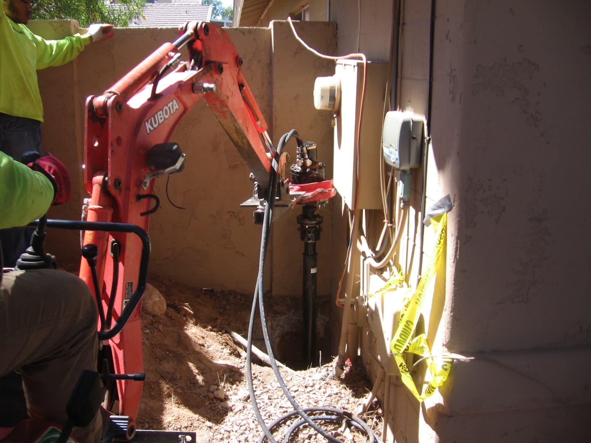 Helical Pier Installation — Tight-Access Stucco Home — photo 1